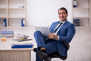 Young male employee working in the office