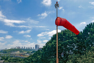 Red windsock inflated of air in heliport in Sao Paulo city, Brazil