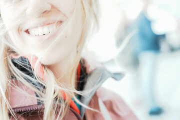 Smile of blonde girl. Beautiful unrecognizable girl with long windblown hair. Youth,...
