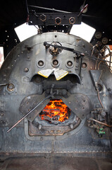 Closeup of old steam locomotive furnace in operation in the tourist city of Guararema, state of Sao Paulo, Brazil