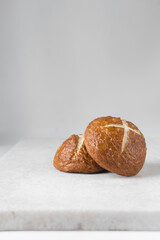 Pretzel buns on a marble tray, German laugenbroetchen, lye buns on a marble tray