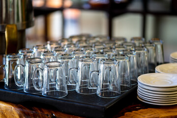 Clean glasses are laid out on trays at the bar.