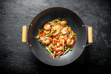 Chinese wok. Asian Udon noodles with shrimp and vegetables.
