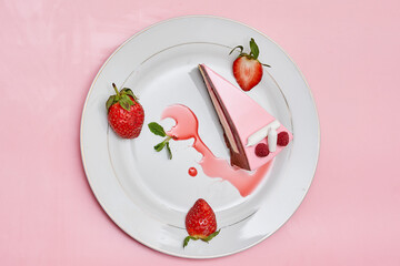 a piece of cake on a plate with strawberries and strawberrys next to it, against a pink background