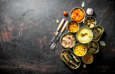 Open tin cans of canned mushrooms, pineapples, corn, meat and fish.