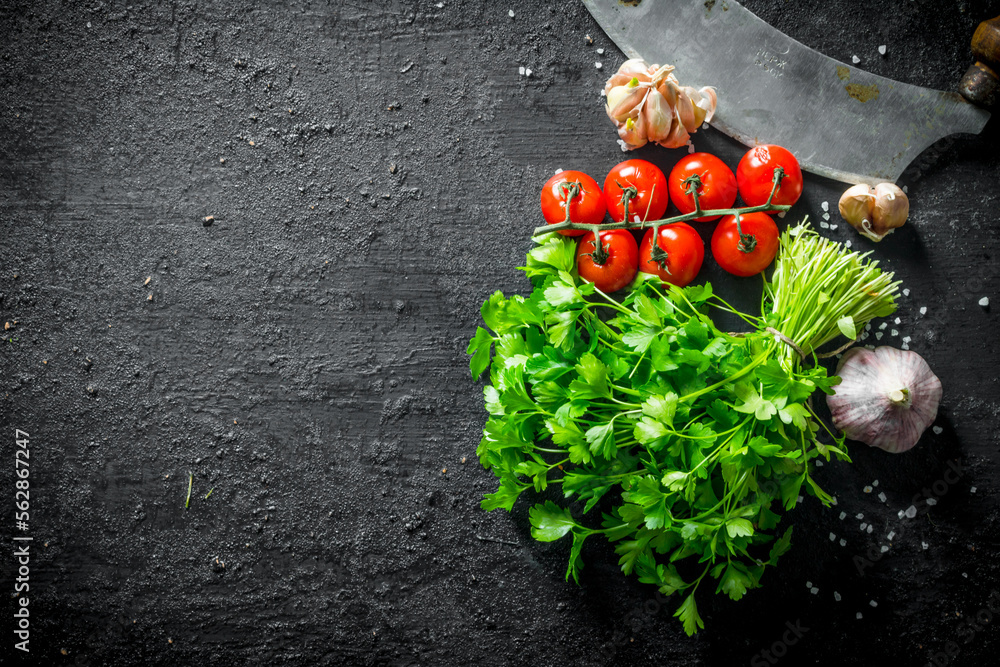 Poster bunch of parsley with cherry tomatoes and garlic cloves.