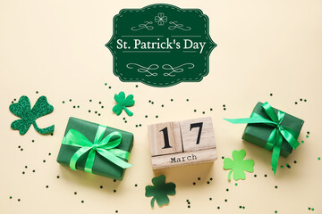 Gifts and calendar with date of St. Patrick's Day on light background - obrazy, fototapety, plakaty