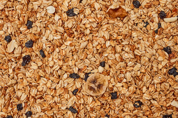oats on top of a pile of muffins with rait and dried raits in the background - Powered by Adobe