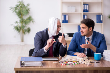 Old male employee suffering from toothache in the office