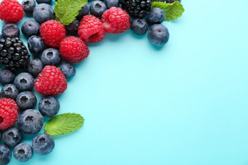Naklejka premium Composition with fresh berries and mint leaves on color background