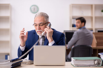 Fototapeta premium Two male colleagues working in the office