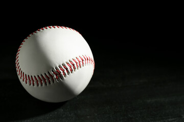 Baseball ball on black background, space for text. Sports game