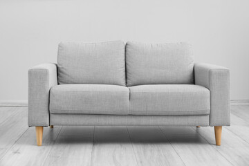 Interior of light living room with grey sofa