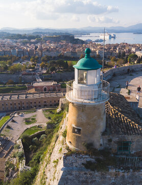 Aerial panoramic drone view of Old Venetian Fortress of Corfu, Palaio Frourio, Kerkyra old town, Greece, Ionian sea islands, with the lighthouse, church and scenery beyond the city, summer sunny day
