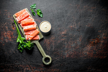 Crab sticks on a cutting Board with sauce and parsley. © Artem Shadrin