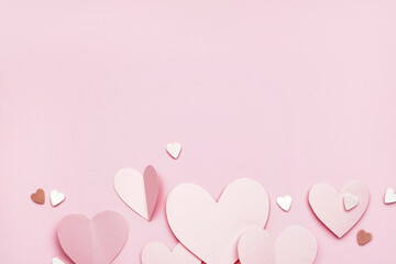 Composition with paper hearts on pink background. Valentines Day celebration