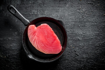 Fresh raw tuna steak in a pan.