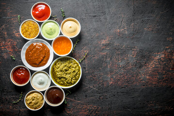 Obraz na płótnie Canvas Barbecue sauce, pesto, mayonnaise, mustard with thyme sprigs.