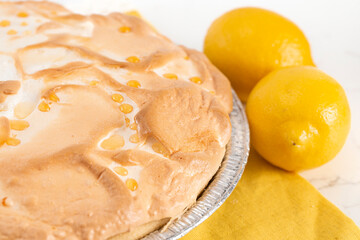 Whole Fresh Lemon Meringue Pie on a Kitchen Counter