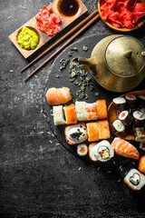 Traditional Japanese sushi with green tea, ginger and soy sauce.