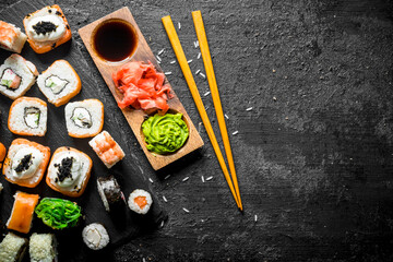 The range of different types of sushi, rolls and Maki with sauces and chopsticks.