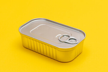 Unopened Tin Can with Blank Edge on Yellow Background. Canned Food. Aluminum Can for Safe and Long Term Storage of Food. Steel Sealed Food Storage Container