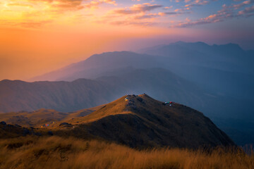 Light rays hitting mountain peaks at sunrise in Burma