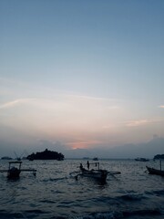 Fototapeta na wymiar Dramatic sunset with boat on beach
