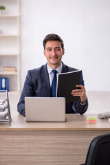 Young male employee working in the office