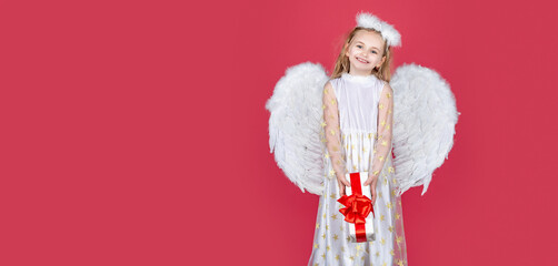 Angel kid banner, isolated studio background. Valentine. Little cupid girl. Kid angel with present. Little angel with white wings holds gift. Horizontal photo banner for website header design