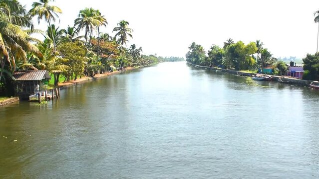 Showing beautiful backwater of alleppey or Alappuzha from House boat. View is from boat bow to sea water. Boat moving through the waves to the destination. 