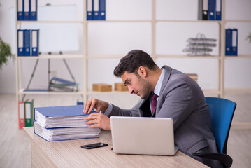 Young male employee working in the office