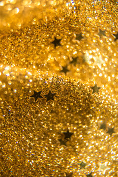 The golden background with sequins is out of focus.