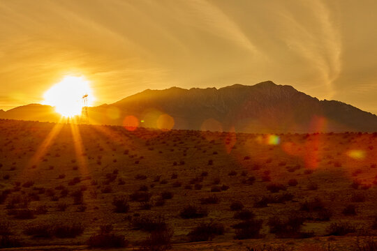 Hot desert sun setting in the west creating sun flare and light glow in a golden moment in California