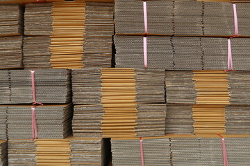 Piles of paper cardboard postal boxes in store factory manufacturer supplier or wholesaler warehouse, waiting for delivery  - obrazy, fototapety, plakaty