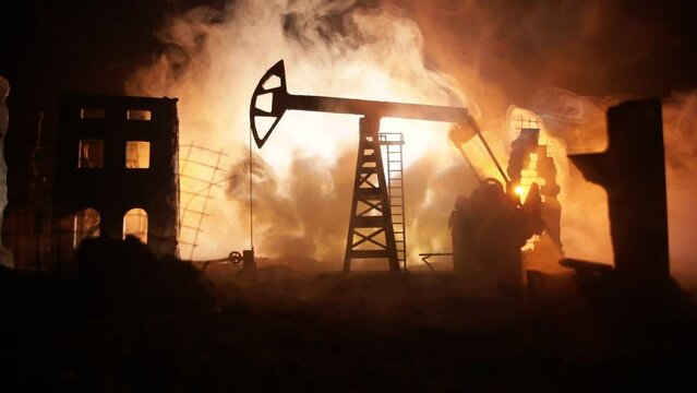 Artwork decoration. Oil war concept. Military silhouettes at oilfield with pumps and rigs. Misty colorful sky background. Armored vehicles fighting scene. Selective focus