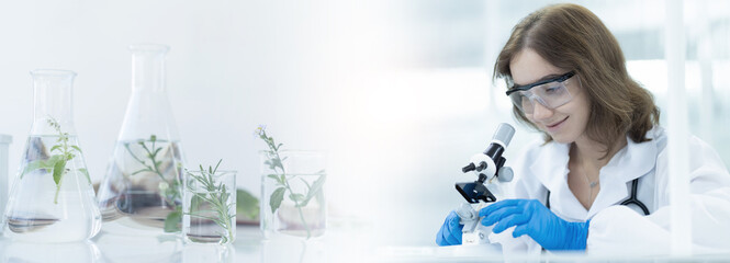 Woman doctor researching through microscope doing analysis for germs and bacteria of test sample in the laboratory. Female scientist working with biotechnology research with microscope