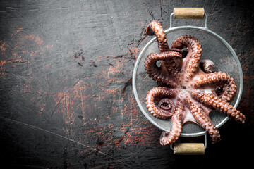 Fresh octopus in a colander.