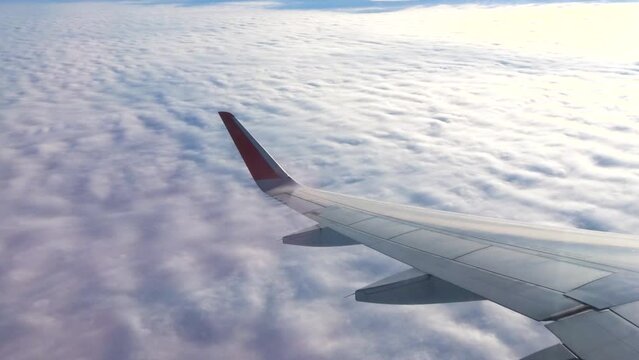 A beautiful view of the cumulus clouds from the airplane window. Concept of an aircraft trip.