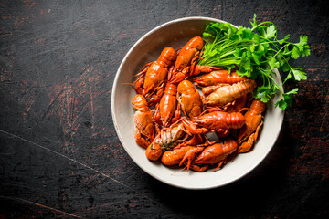 Boiled crayfish in a bowl with parsley.