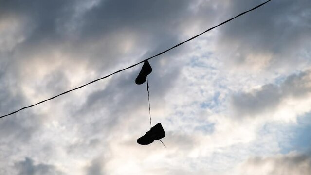 Shoes Hanging From Wire In Urban Setting