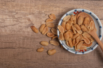 Peanuts in a cup on wooden background