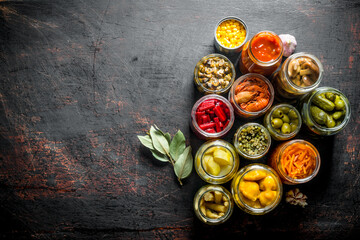 Various preserved food in jars with Bay leaf.
