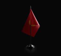 Small national flag of the Kirghizia on a black background