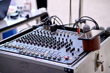 Closeup Analog sound mixer with selected focus. Professional audio mixing console broadcasting.