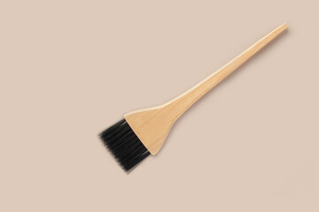A brush for coloring hair. Professional brush for applying hair dye in the beauty industry. Wooden...