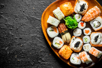 Different kinds of sushi rolls on the plate.