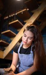 Pottery artist, Young female making a piece of clay molding calmly and meticulously In order to produce the most attractive work possible,