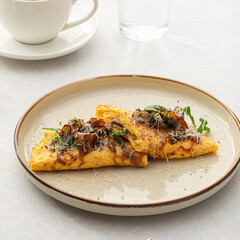 Portion of gourmet omelette with mushrooms and cheese