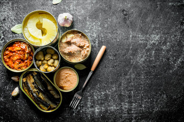 Set of different types of cans of canned food.